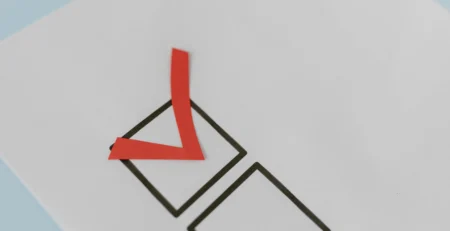 A red Check Mark in a Box for a urgent Police Clearance Certificate