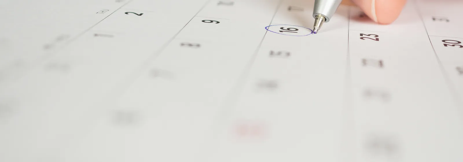 A pen marking a date on a calendar page